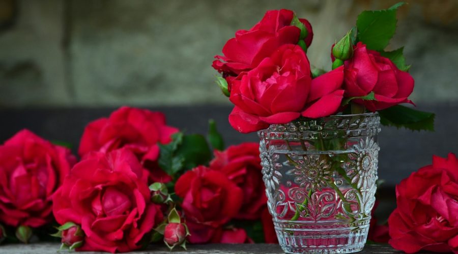 Roses piled up around a vase of roses